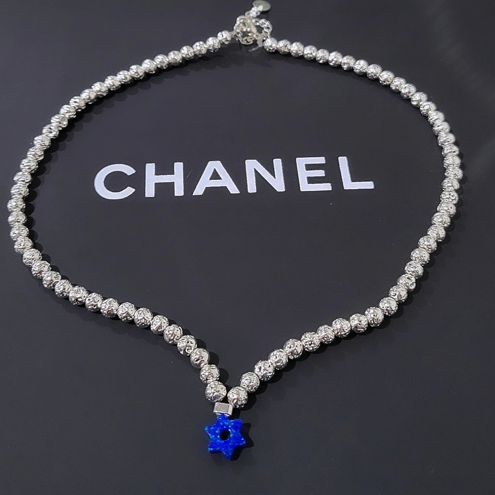 Silver volcanic rock with David star choker